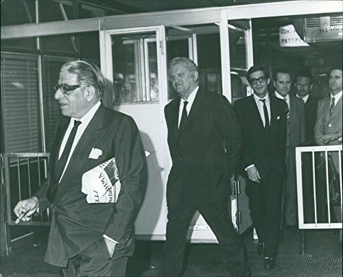Foto vintage de Aristóteles Sócrates Onassis andando com poucos homens atrás dele, 1972.